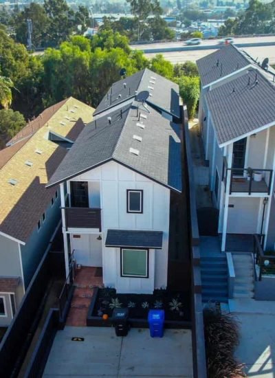 Aerial view of contemporary residential buildings featuring diverse roofing and outdoor spaces.